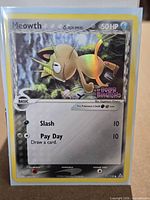 Front of Meowth reverse holo card in sleeve