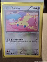 Front of Audino full holo card inside sleeve showing condition and holographic pattern