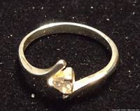 Top view of sterling silver bypass ring with CZ stone