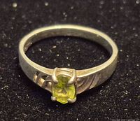 Front view of sterling silver ring with peridot