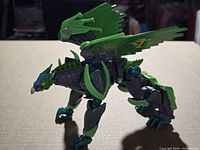 Left side view showing full beast mode, wings extended, limb articulation, color scheme