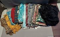 Stack of mixed scarves and shawls
