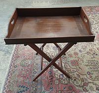 Top view of mahogany tray on stand showing surface and handles