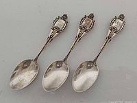 Front view of three Birks WMRC sterling teaspoons