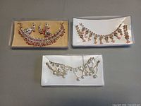 overview of three boxed jewellery sets