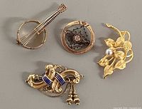 All four gold tone brooches overview