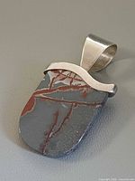 Front view of pendant showing jasper pattern and silver bezel