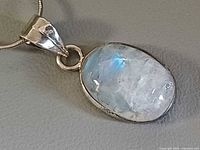 Close-up of moonstone pendant showing bezel setting and sterling bail