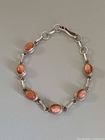 Full view of sterling silver bracelet with six sunstone cabochons