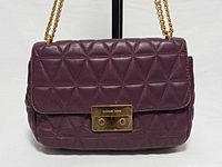 Front view showing quilted leather pattern and gold turn-lock closure