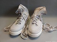 Front and top view of both sneakers with laces displayed