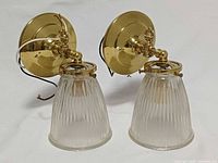 Front view of both brass wall sconces with shades