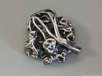 Front view showing overall floral vine design and silver finish