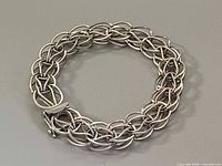 Top view of entire bracelet showing woven interlocking links and clasp