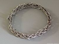 Full view of the woven sterling silver bracelet arranged in a circle