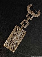 Full view of brooch front showing design and stones