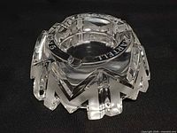 Oblique view showing Baccarat crystal ashtray with frosted M forms and etched Martell rim