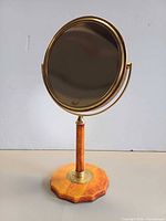 Front view showing brass-tone frame and Bakelite base