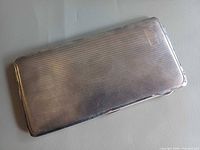 closed view of textured silver-plated cigarette case
