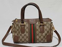 Front view of Gucci GG Supreme Boston bag showing Web stripe, GG canvas, leather trim, handles and strap