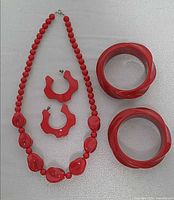 Full view of necklace, earrings, bangles