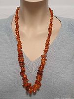 Amber chip necklace on mannequin front view