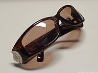 Front and side view showing Versace logo on lens and Medusa emblem