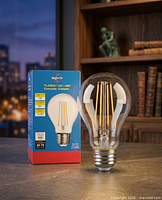 Sealed retail box beside one Bright Or filament LED bulb