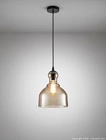 Front view of amber glass pendant with matte black canopy and cord