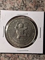 Obverse of coin in 2×2 holder on granite background