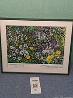 Front view of framed floral event poster