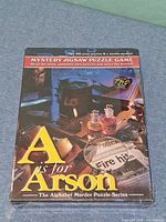 Front of sealed A Is for Arson puzzle game box