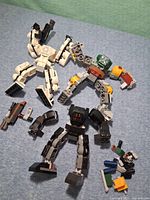 Overview of three partial mech builds and loose pieces