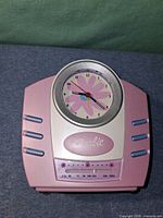 Front view of Barbie clock radio showing dial, logo and radio scale