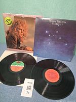 Front covers of both albums and both vinyl discs displayed