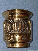 Front view showing calligraphy relief and polished finish