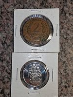 Fronts of both coins in flips showing denomination and dates