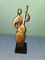 front view of bronze abstract musician sculpture on wood base