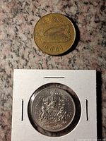 Irish 20p harp obverse above Canadian 50c reverse in flip
