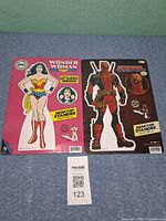 Front view of both sealed desktop standees with MaxSold lot ID