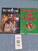 Front covers of both hardcovers with MaxSold lot tag visible