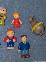 Close-up left side figures including hippo, dad, businessman, girls