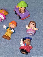 Close view of jeep with safari driver, female child, doctor and construction worker figures