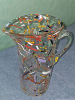 Front angled view showing overall form, multicolor flecks and clear handle