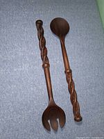 Full view of both wooden salad servers on fabric background