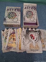 Deck box, open box with guidebook, spread of cards