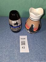 Both ceramic vases side by side showing size and designs