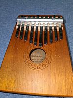 Front view showing 10 metal tines, bridge, sound hole and model marking