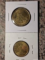 Greek 50 Drachmai coin obverse with trireme, Estonian 1 Kroon coin reverse with denomination, each in flip