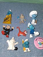 Group shot of all eight Smurfs figures plus pin